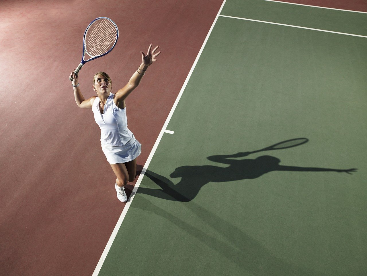 Tennis athlete serving during a match, illustrating how medical acupuncture supports sports injury recovery, pain relief, improved mobility, and peak athletic performance at ActiveCare Physical Therapy in Midtown Manhattan, New York City.