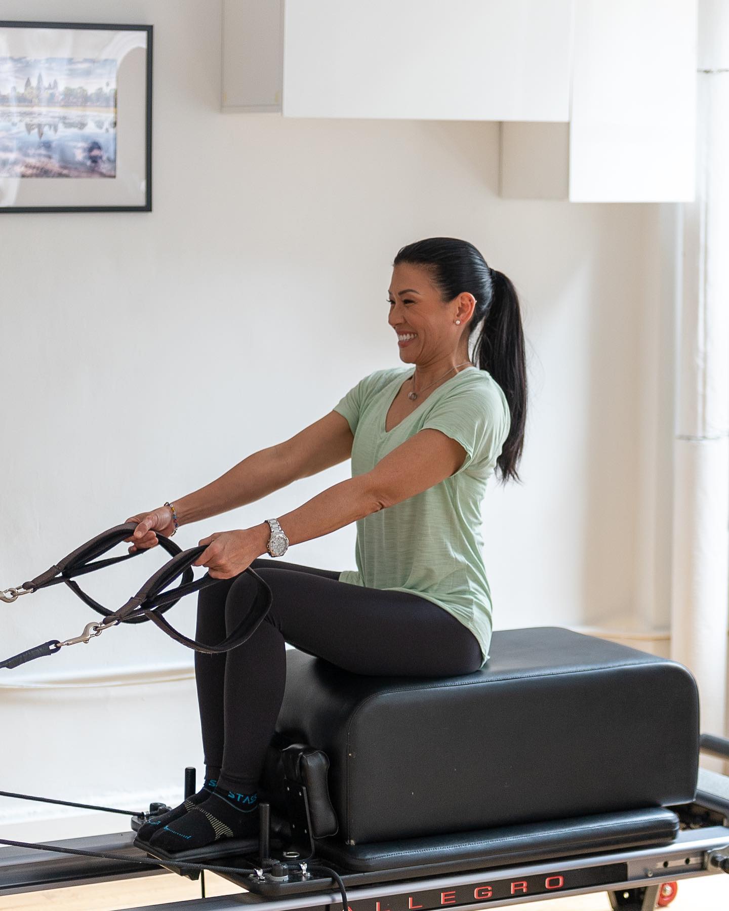Dr. Karena Wu performing Clinical Pilates Reformer exercises to improve core strength, posture, balance, flexibility, and functional movement at ActiveCare Physical Therapy in Midtown Manhattan, New York City.