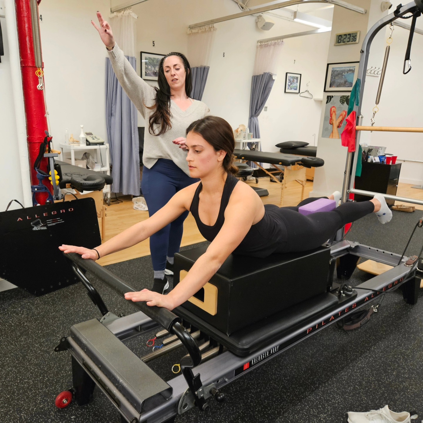 Physical therapist guiding a patient through a Clinical Pilates Reformer exercise to improve core strength, posture, balance, mobility, and injury recovery at ActiveCare Physical Therapy in Midtown Manhattan, New York City.