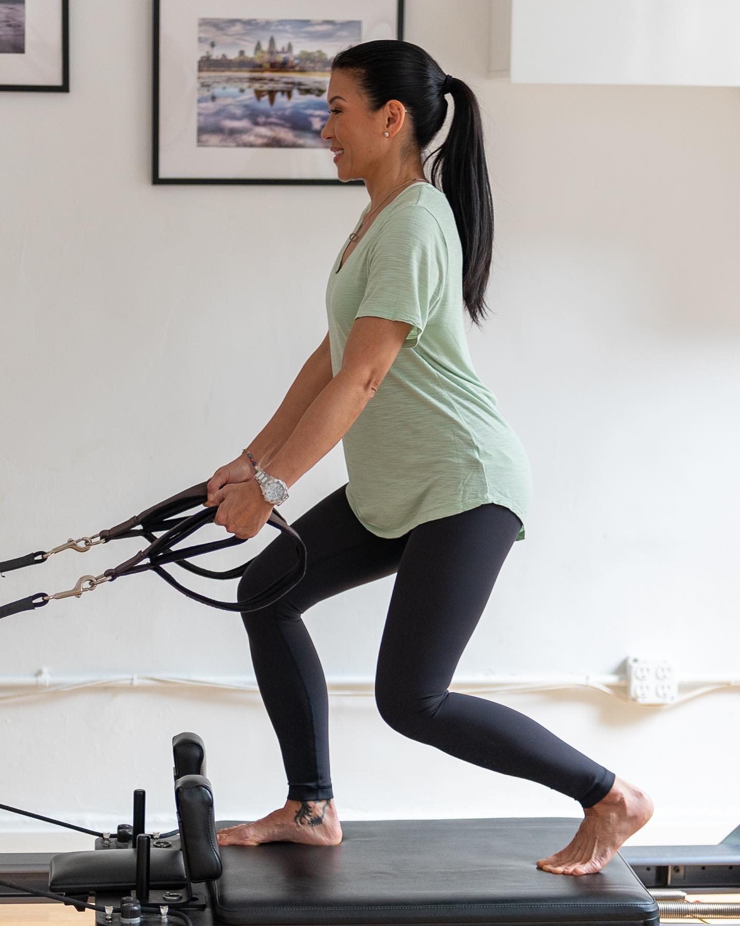 ActiveCare Physical Therapy NYC patient performing a clinical Pilates reformer resistance lunge exercise to improve balance, lower body strength, and stability.