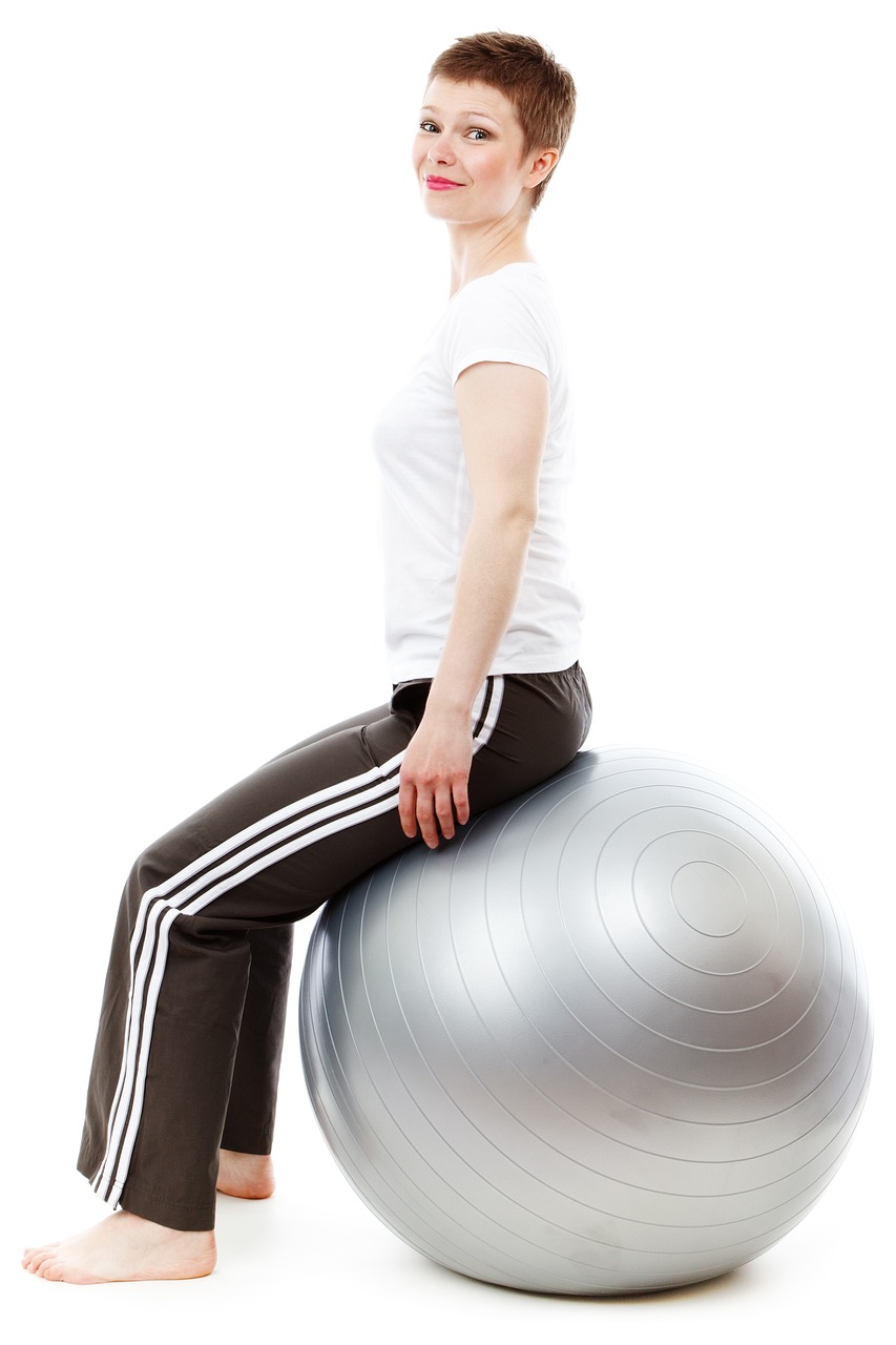 Patient performing a Clinical Pilates stability ball exercise to improve posture, core strength, balance, flexibility, and spinal alignment at ActiveCare Physical Therapy in Midtown Manhattan, New York City.