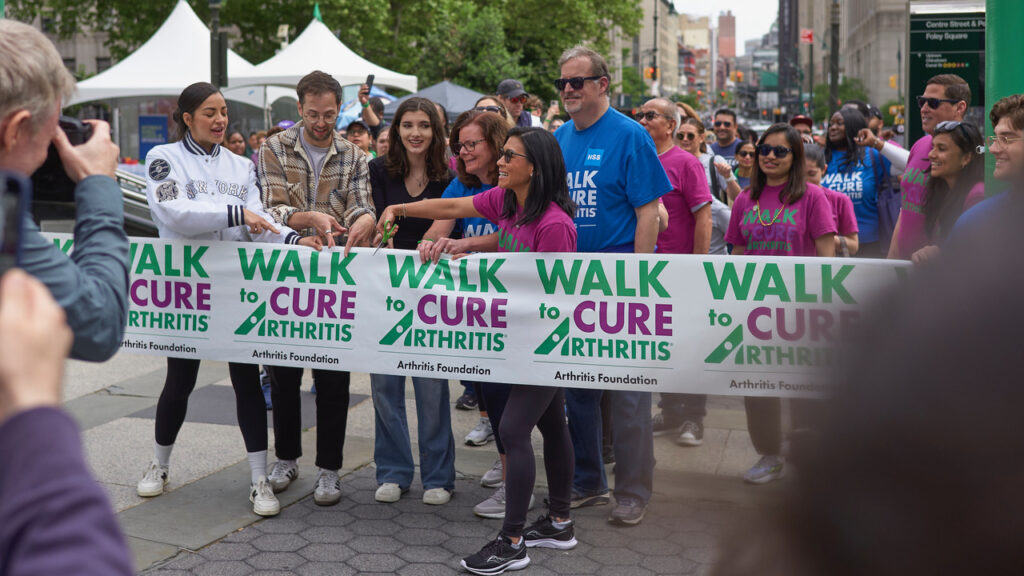 Dr. Karena Wu participating in the Arthritis Foundation Walk to Cure Arthritis ribbon-cutting ceremony with community leaders and supporters in New York City.